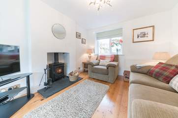The cosy first of two sitting-rooms, ideal for family evenings spent watching a film (the wood-burner is not for guests' use).