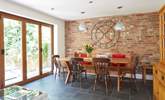 The open plan layout from the kitchen/dining-room is emphasised with the bi-folding doors leading to the patio area. - Thumbnail Image