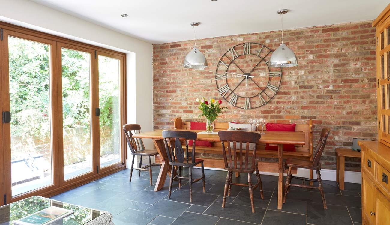 The open plan layout from the kitchen/dining-room is emphasised with the bi-folding doors leading to the patio area.