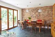 The open plan layout from the kitchen/dining-room is emphasised with the bi-folding doors leading to the patio area.