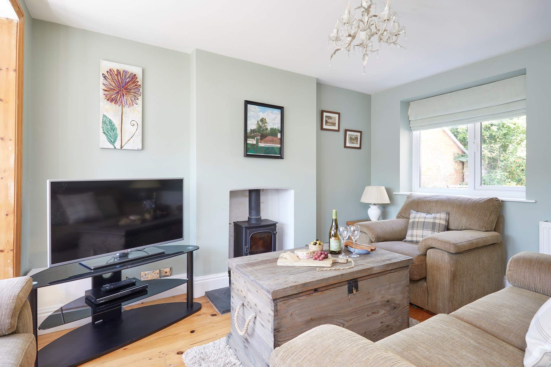 The cosy first of two sitting-rooms, ideal for family evenings spent watching a film (the wood-burner is not for guests' use).