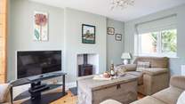 The cosy first of two sitting-rooms, ideal for family evenings spent watching a film (the wood-burner is not for guests' use).