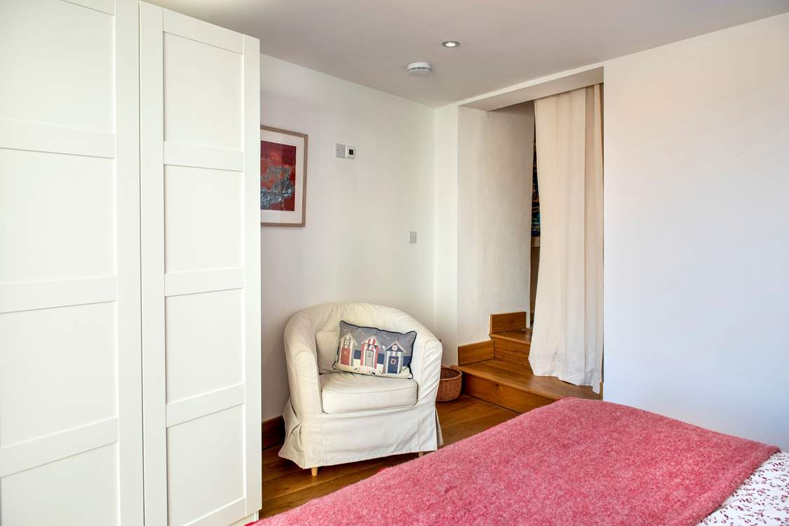 Steps lead out from bedroom 1 to a utility-area, shower-room and the stairs to the upper floors.