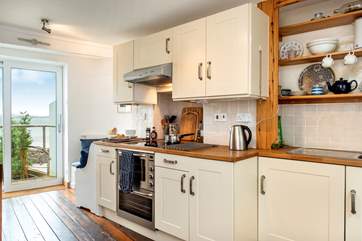 From the kitchen the large windows open up leading you out to the higher decking area.