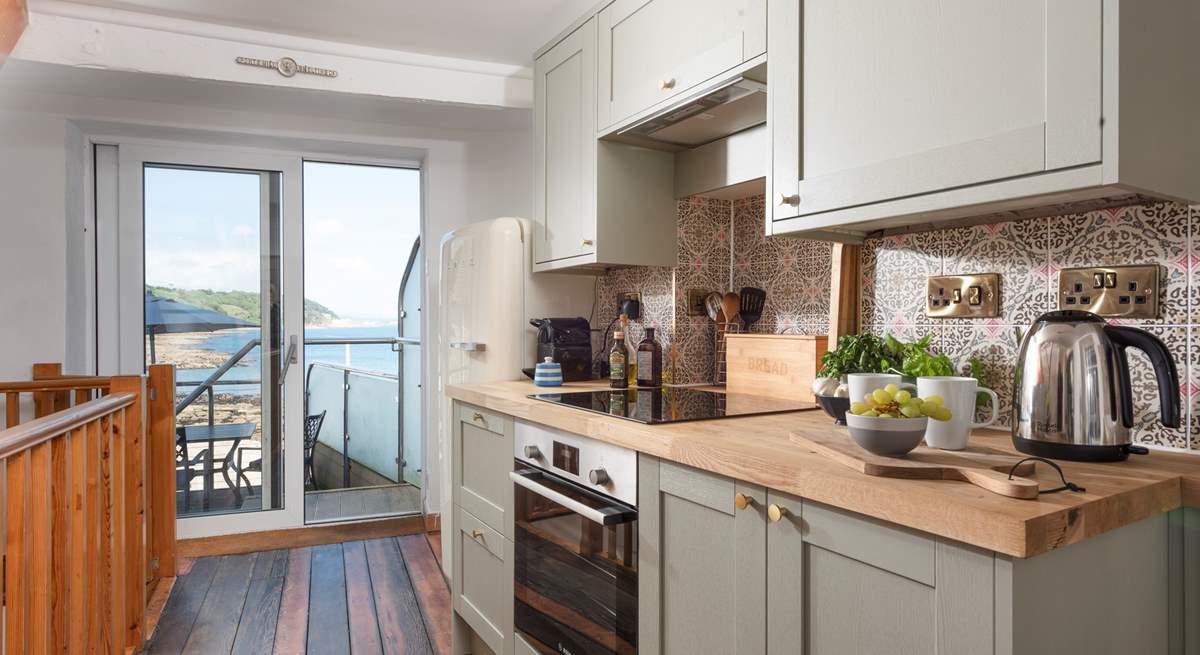 The cottage kitchen is on the ground floor with direct access to the upper terrace area.