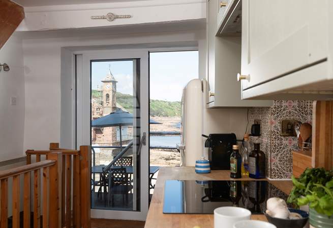 The view stretches across the beach to the village's iconic village hall and clock tower.
