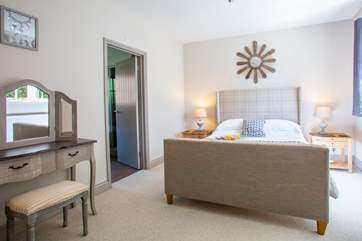 Spacious bedroom with door to en suite.