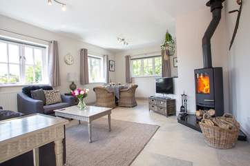 The luxury open plan living area complete with a cosy wood-burning stove.