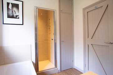 Large walk-in shower with two shower head options.