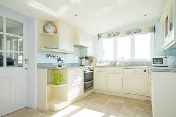 The utility-room is off the kitchen, with washing machine and drier, and plenty of space to store your outside games equipment to grab and go.