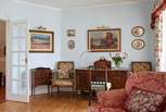 Exquisite paintings and a beautiful writing desk in the sitting room.