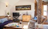 The spacious living area with stripped oak floors and ancient beams. - Thumbnail Image