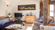 The spacious living area with stripped oak floors and ancient beams.