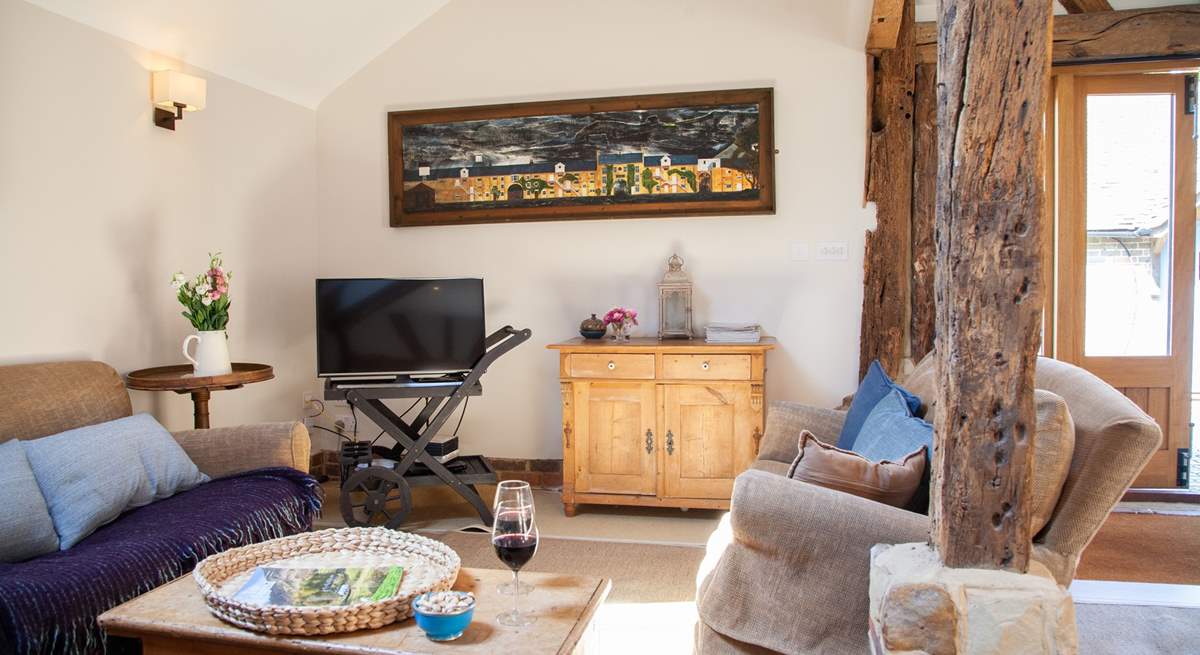 The spacious living area with stripped oak floors and ancient beams.