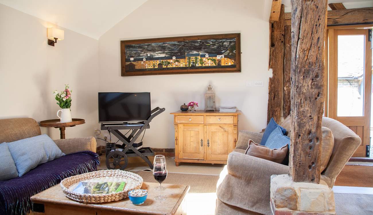 The spacious living area with stripped oak floors and ancient beams.