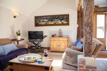 The spacious living area with stripped oak floors and ancient beams.