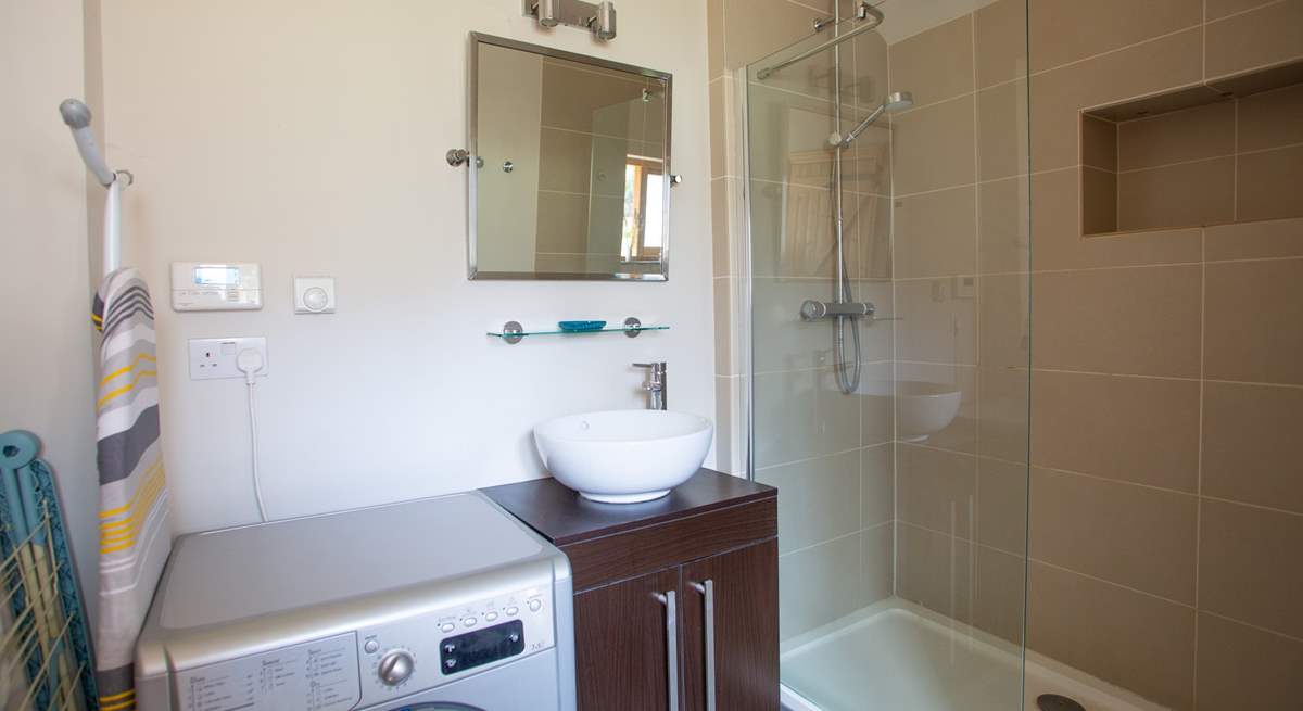 Downstairs shower-room with walk-in shower and washing machine/drier. 