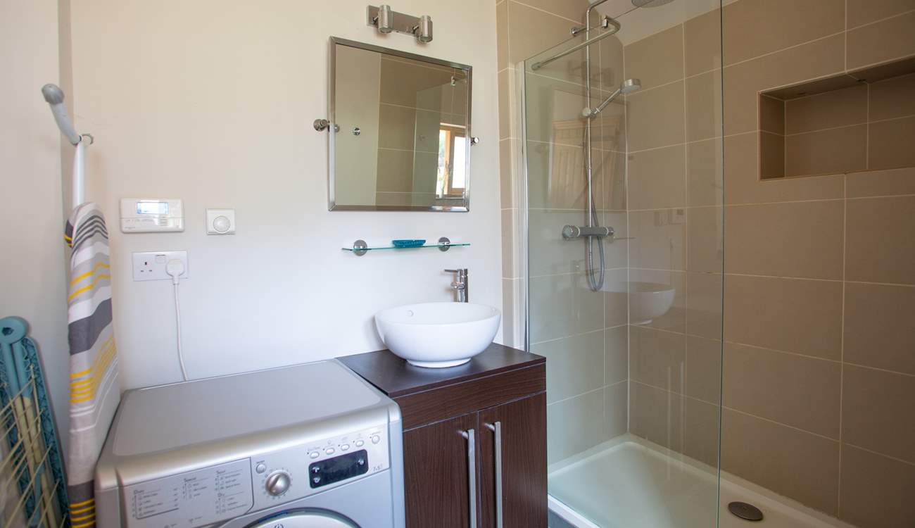 Downstairs shower-room with walk-in shower and washing machine/drier. 