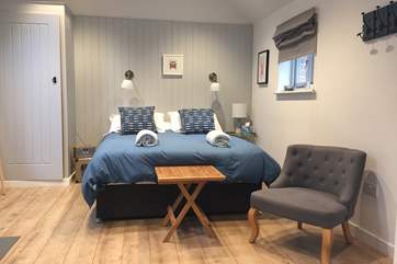 The open plan bedroom area with a comfortable large king-size double bed.