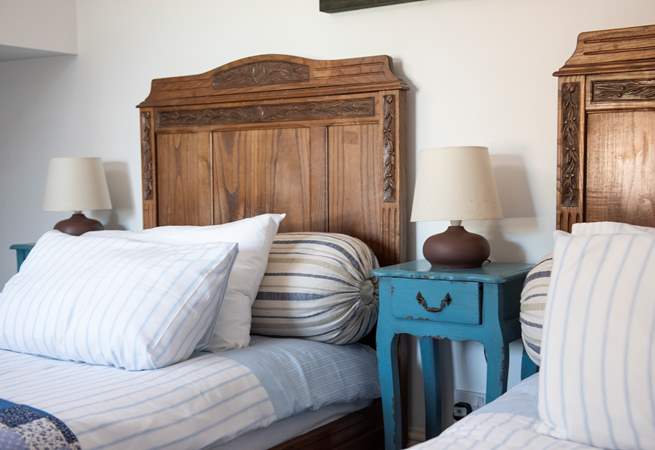 Gorgeous vintage twin beds feature in this bedroom.