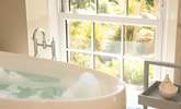 Enjoy the views of the gardens to the sea beyond from the comfort of the bath tub. - Thumbnail Image