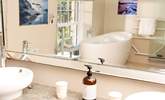 The main bathroom with a deep bath tub, perfect for sinking under the bubbles for some full on relaxation. - Thumbnail Image