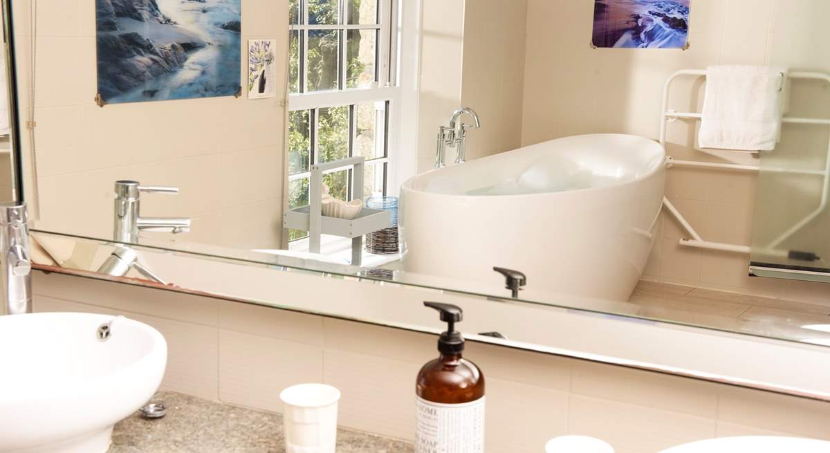 The main bathroom with a deep bath tub, perfect for sinking under the bubbles for some full on relaxation.