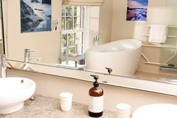 The main bathroom with a deep bath tub, perfect for sinking under the bubbles for some full on relaxation.