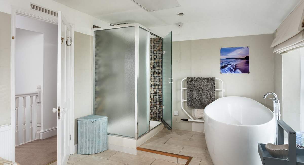 The family bathroom is incredibly spacious with a large shower cubicle and bath big enough for two sitting on the raised bathing platform at one end of the room.