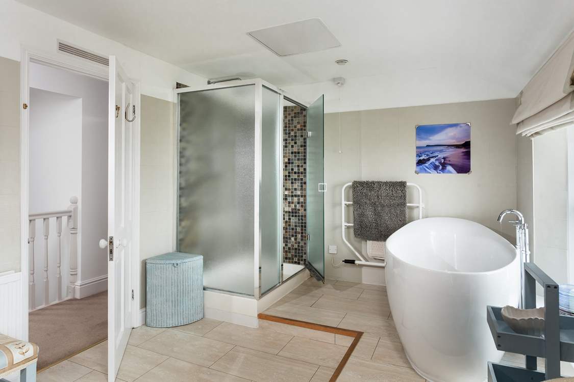 The family bathroom is incredibly spacious with a large shower cubicle. Sitting on a raised platform at one end of the room, the large bath is big enough for two.