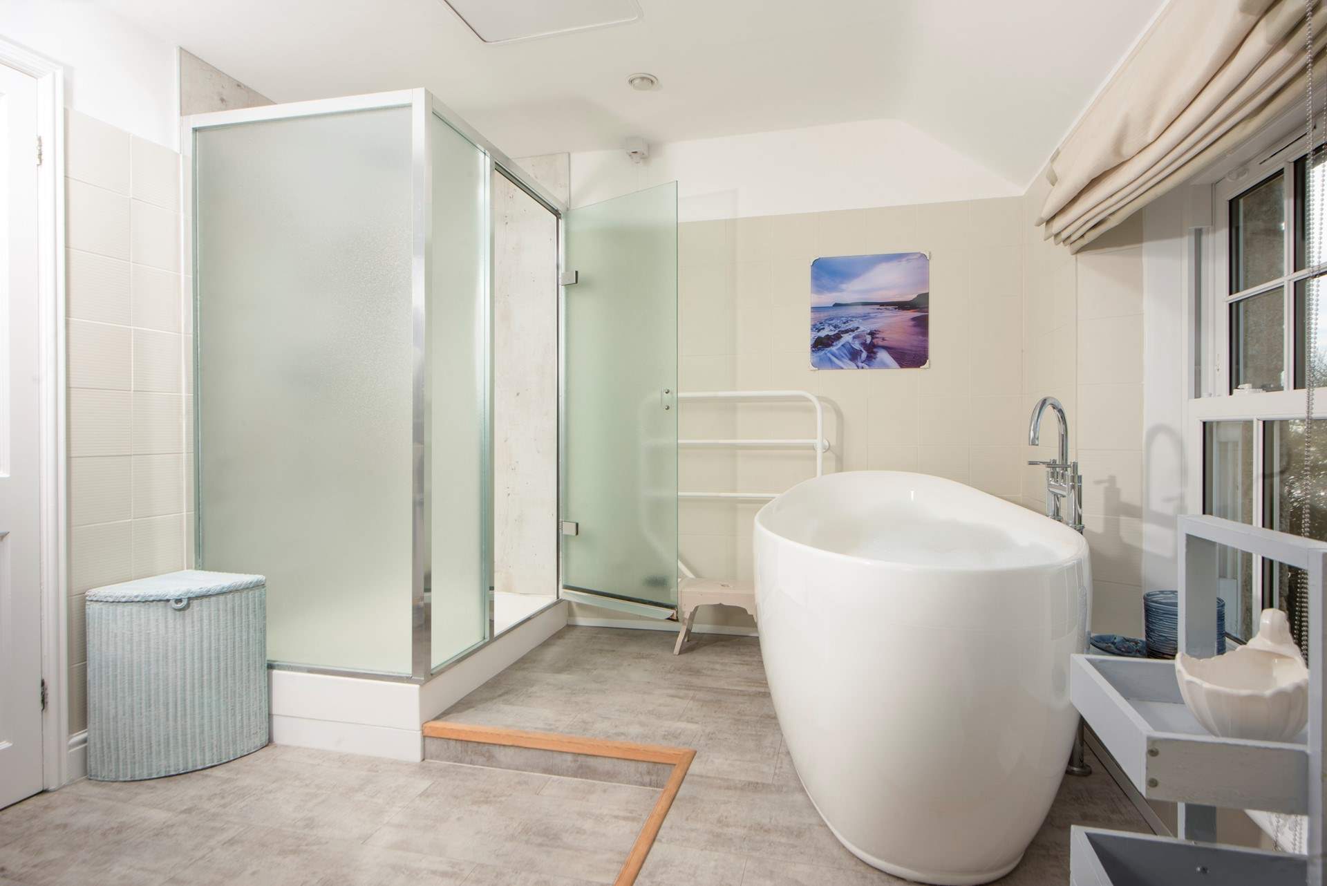 The family bathroom has a large bath and separate shower cubicle.