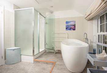 The family bathroom has a large bath and separate shower cubicle.