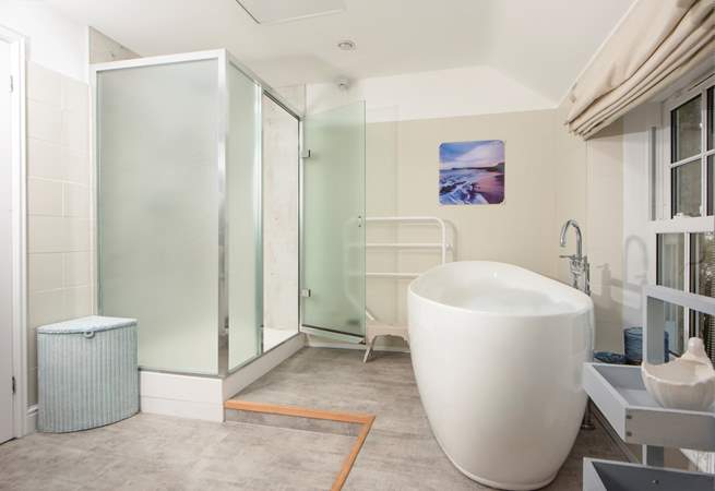 The family bathroom has a large bath and separate shower cubicle.