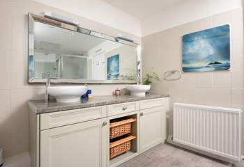 The stylish family bathroom has a double basin.