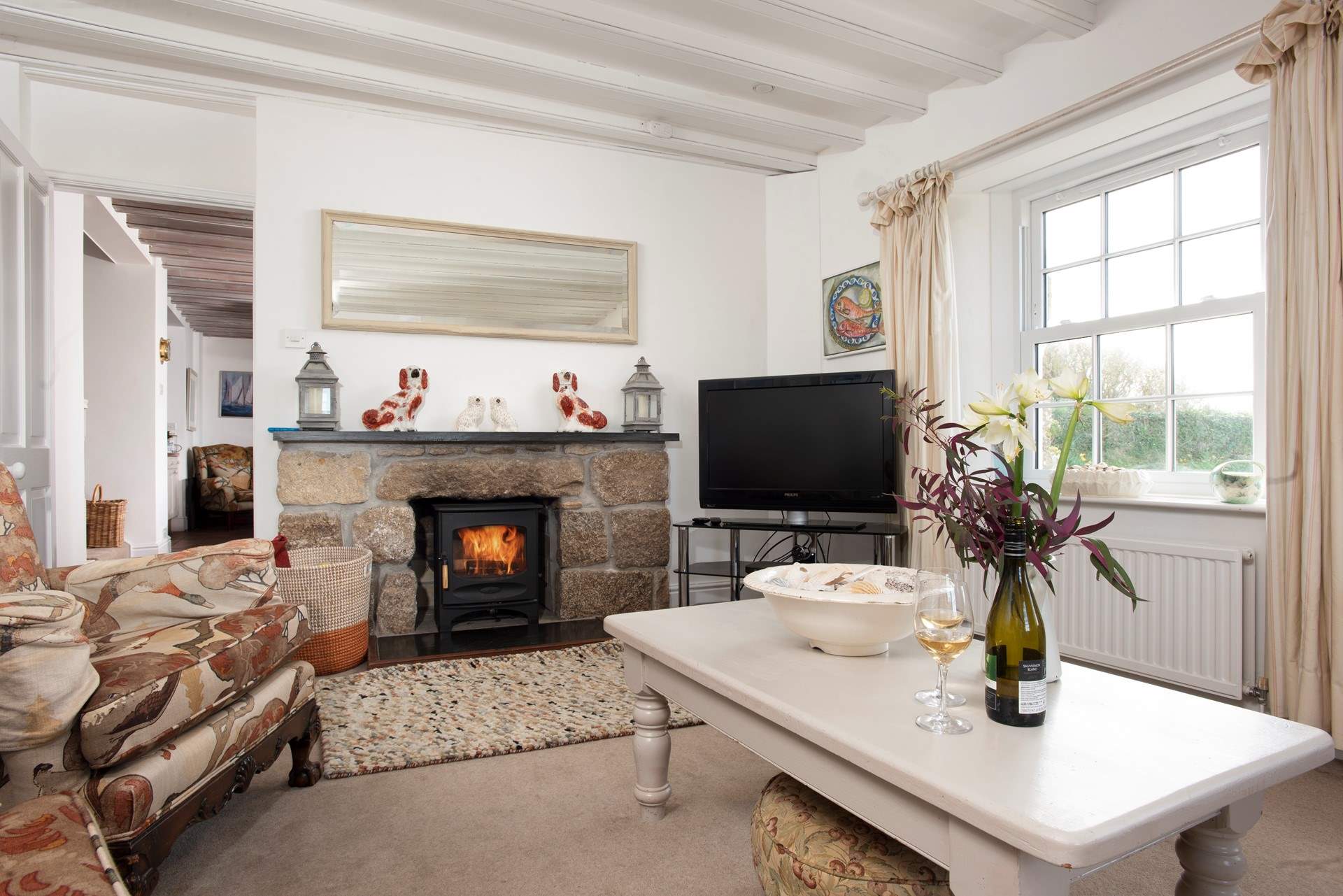 Lounge by the flickering flames of the wood-burner.