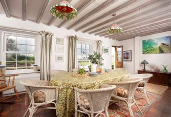 The spacious dining area has access to the front lawn and terrace.