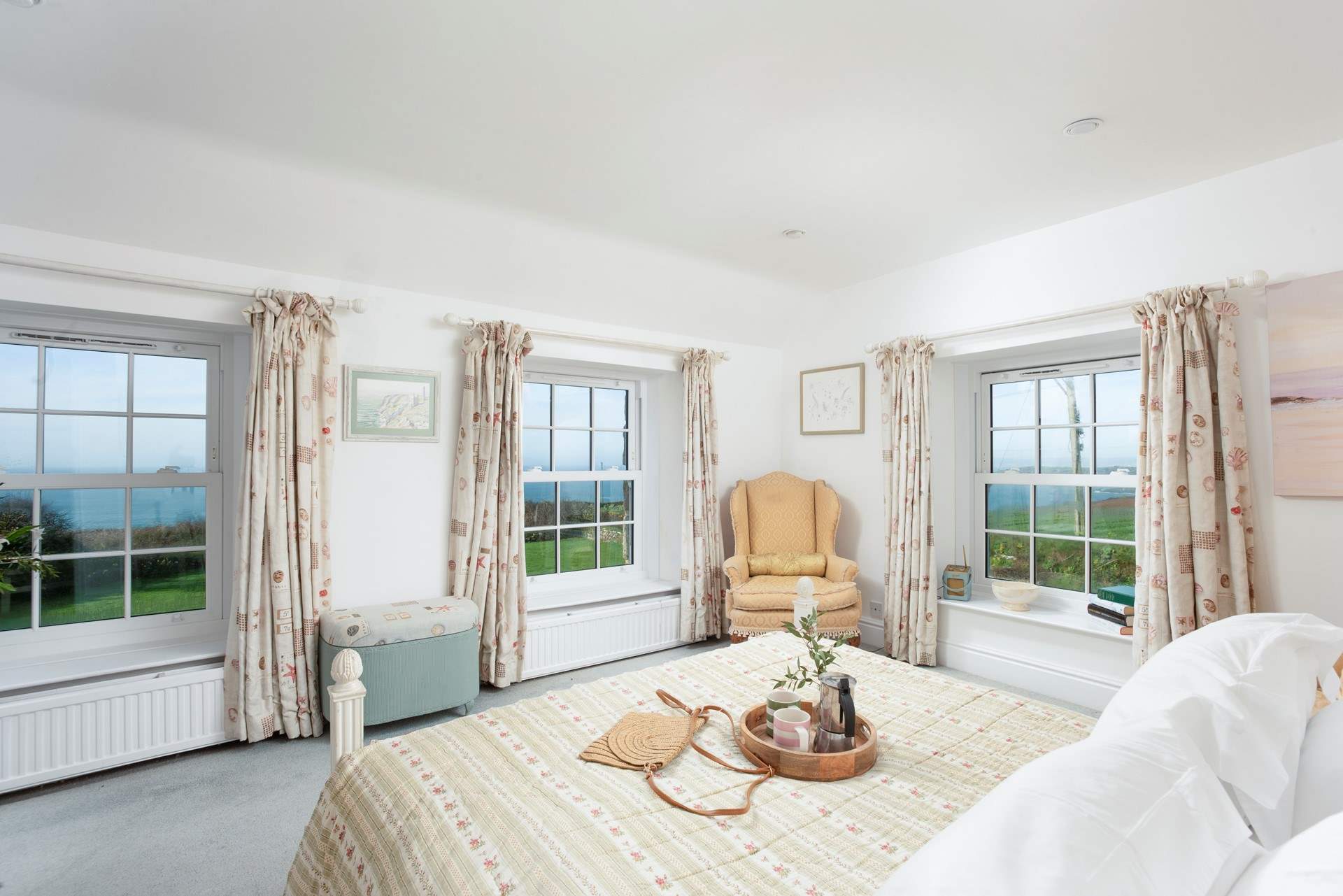 This bedroom boasts a triple aspect to frame the dramatic backdrop.