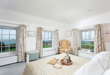 This bedroom boasts a triple aspect to frame the dramatic backdrop.