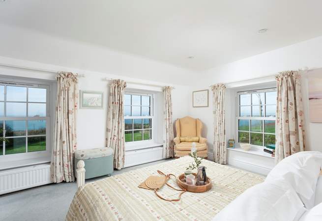 This bedroom boasts a triple aspect to frame the dramatic backdrop.