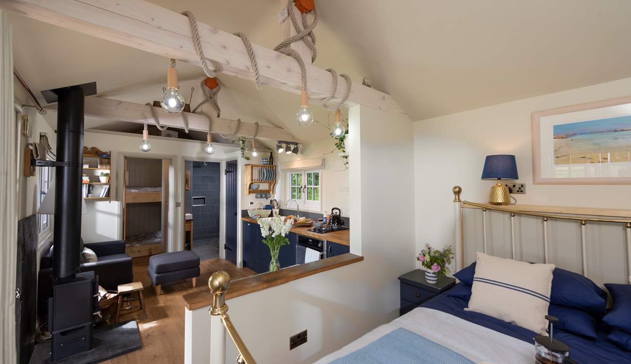 The comfy king-size double bed is tucked away at one end of the cabin.