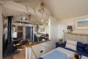 The comfy king-size double bed is tucked away at one end of the cabin.