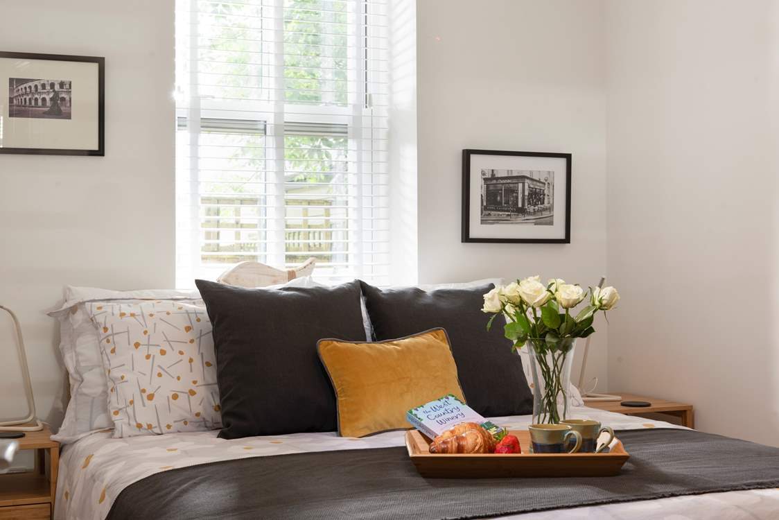 Pretty bedroom has a king-size bed.