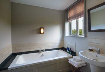 The family bathroom has a gorgeous bathtub. 