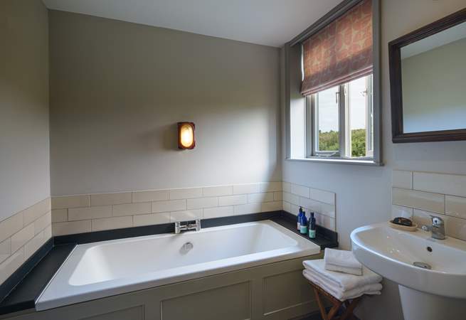 The family bathroom has a gorgeous bathtub. 