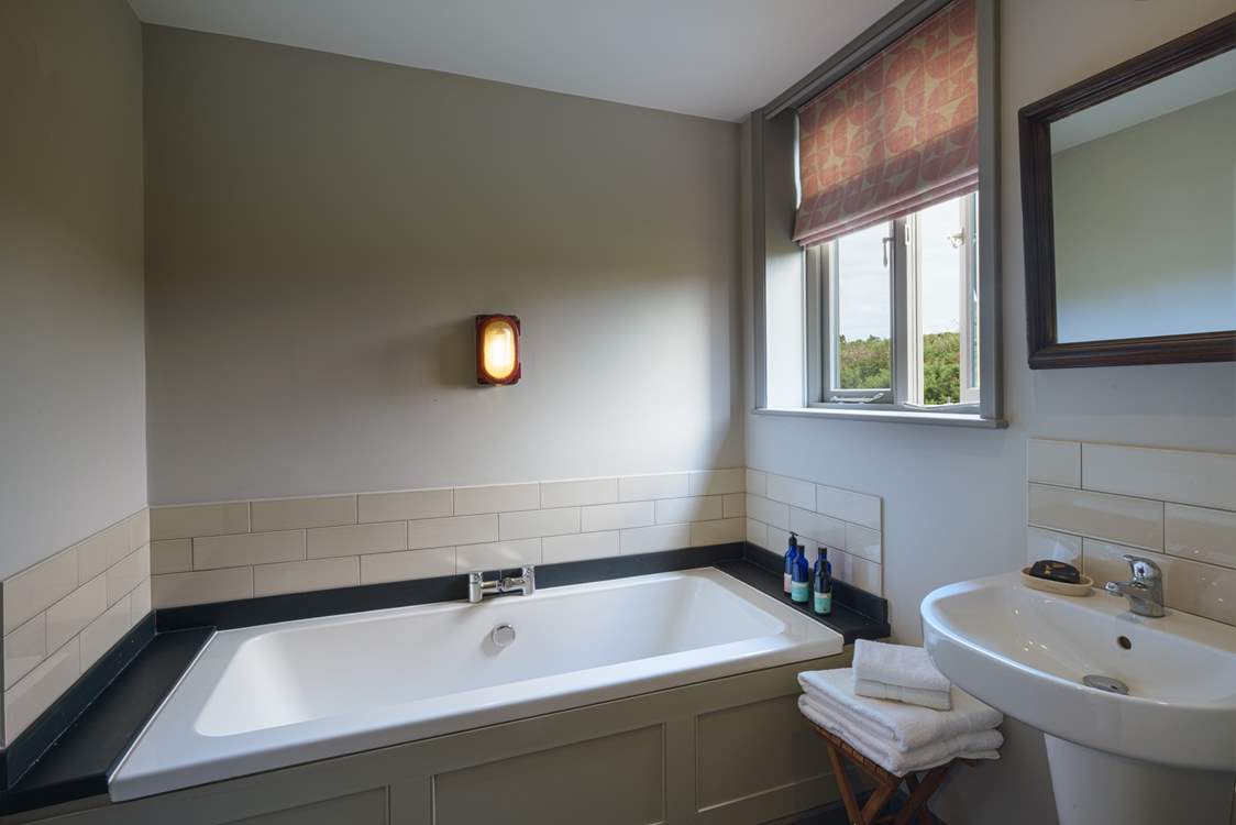 The family bathroom has a gorgeous bathtub.