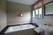 The family bathroom has a gorgeous bathtub.