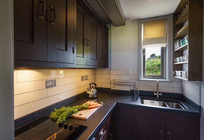 The hand-crafted kitchen is equipped with everything you should need during your stay. 