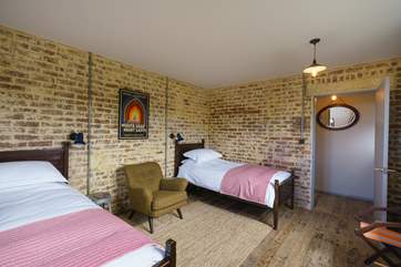 Delightful twin bedroom with a bespoke made chair.