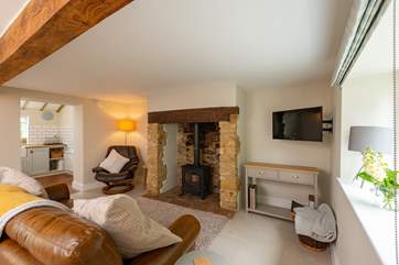What a special fireplace! Light the fire and sink back in to the comfortable sofa.