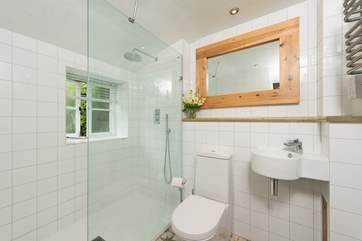 The ground-floor bathroom has a luxurious drench-head walk-in shower.